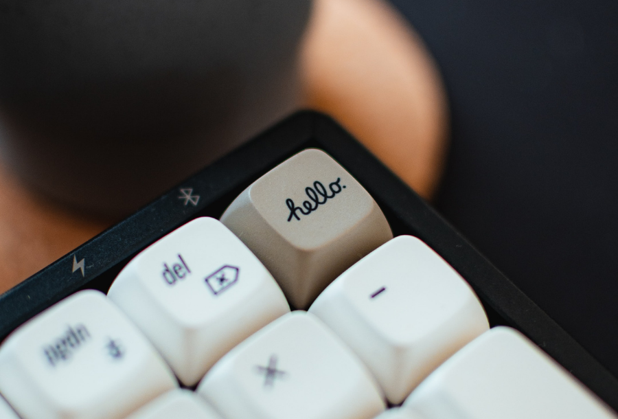 Picture of the top right hand side of a keyboard, with the top right hand button saying "hello"
