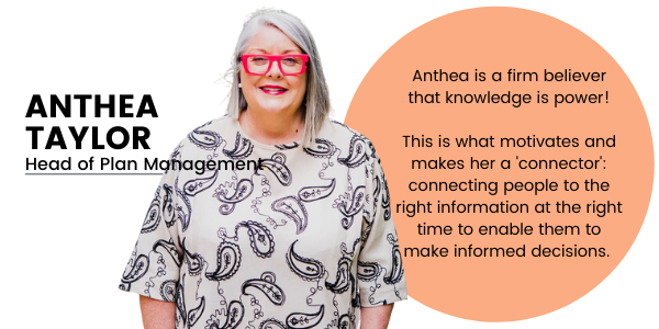 Head of NDIS Plan Management Anthea Taylor stands centre in the photograph wearing thick red framed glasses and wearing a white dress with a large black paisley print covering