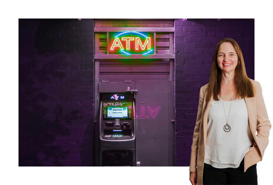 Pictured, Financial Adviser Samantha Butcher standing in front of an old school ATM with a purple background and neon "ATM" letters