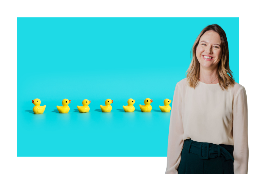 Pictured on the right hand side, our senior lawyer Gabrielle Anderson standing in front of a an aqua blue background with little rubber yellow ducks in a row