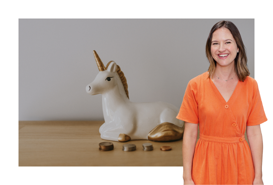 Pictured, our Senior Solicitor Gabrielle Andersen wearing a bright orange dress standing in front of a stock picture of a unicorn money box on a wooden table
