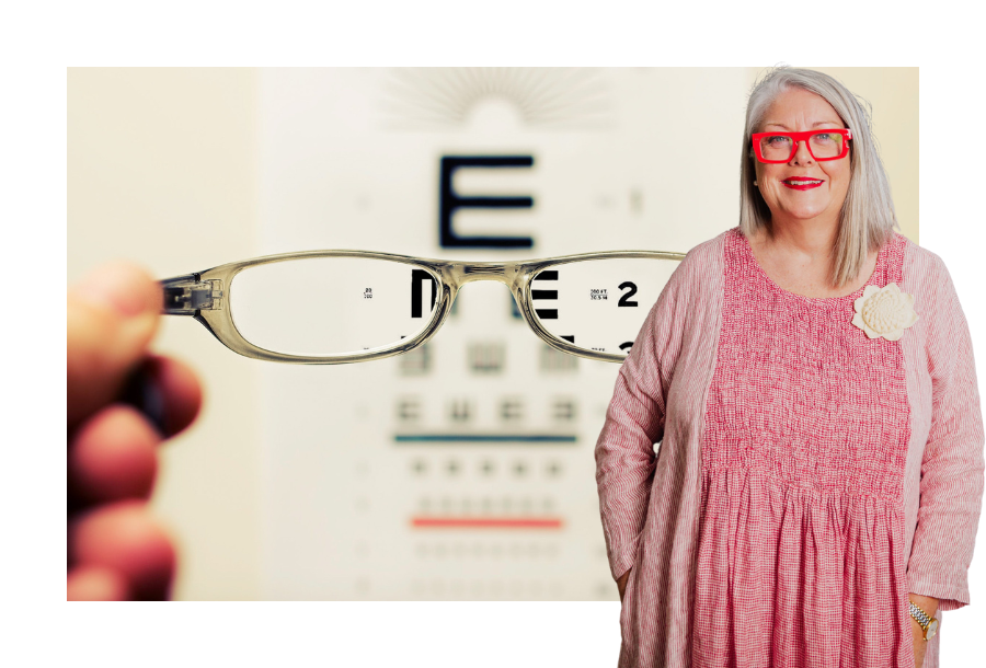 Pictured, Anthea Taylor in a red striped dress and a cream coloured rose broach standing in front of a stock picture of a pair of hands holding up a pair of glasses against an eye test chart.