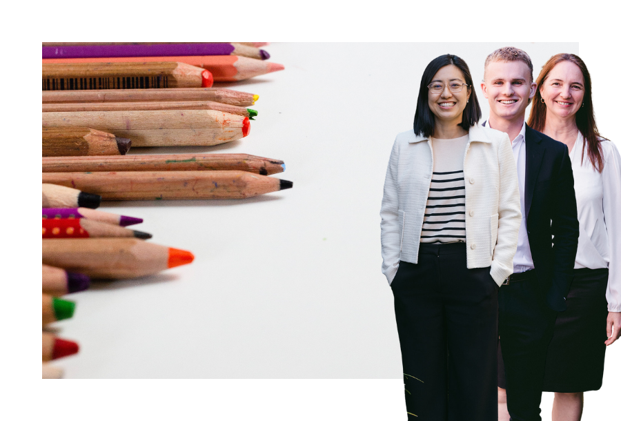 Pictured: Our Financial Advice team, Helen, Jayden and Sam standing smiling. Behind them is an image of used coloured pencils laying on a white background.