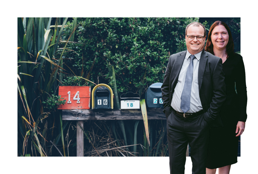 Pictured; Adam Wightman and Karlene Wightman, standing smiling in front of a row of mailboxes.