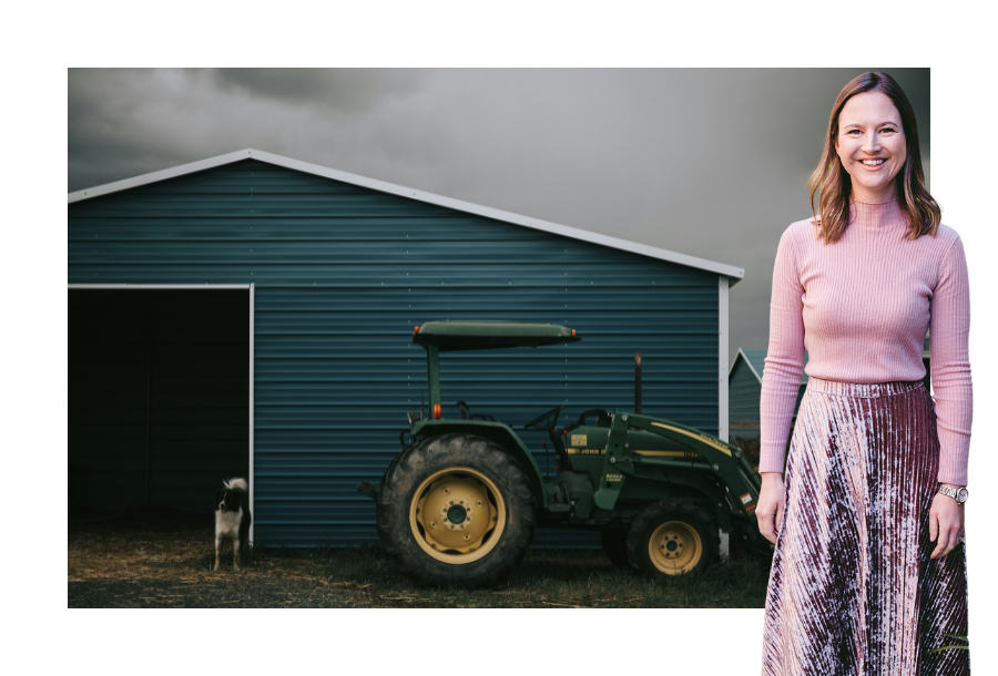 Pictured; Gabrielle Andersen standing smiling in a pink long sleeve shirt and long pink skirt. Behind her is an image of a shed, farm dog and green tractor.