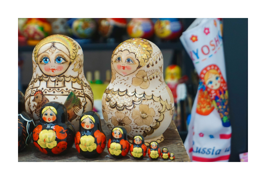 Pictured, a table with different sized babushka dolls, small, medium and big sizes and all in different bright and beautiful colours